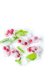 Obraz na płótnie Canvas fresh cranberry in ice cubes on white background top view mock-up