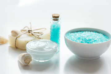 Plakat spa composition with blue sea salt and natural soap on white desk background
