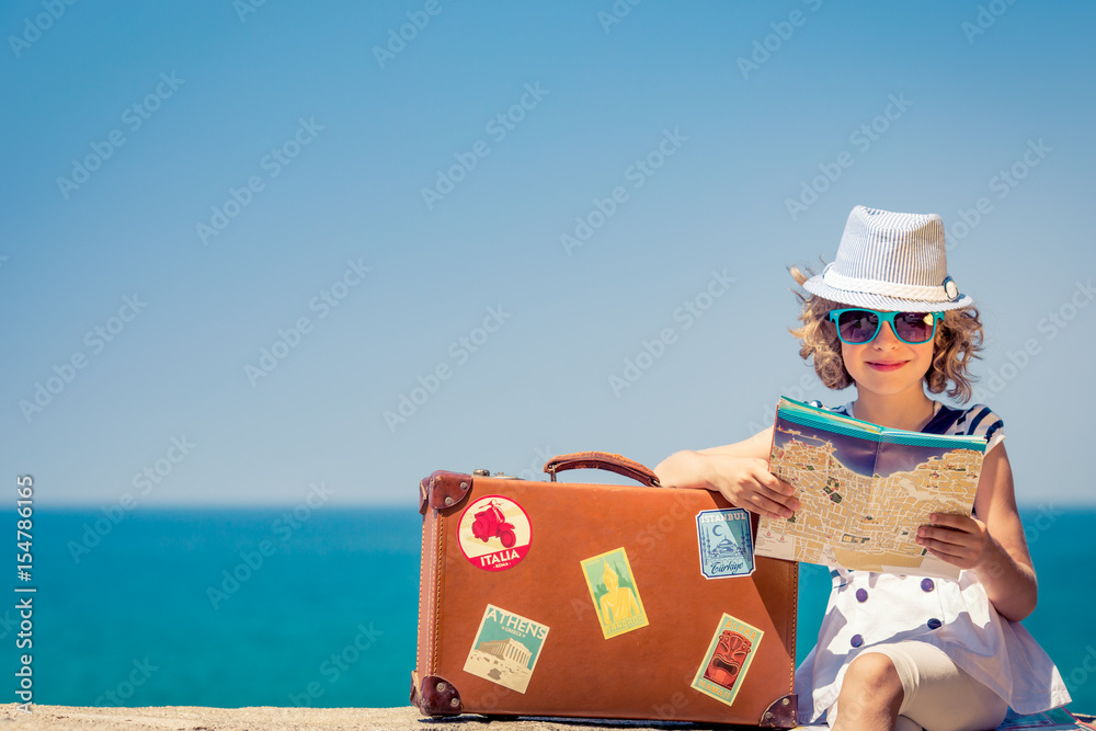 Poster child with vintage suitcase on summer vacation