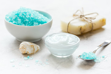 Fototapeta na wymiar blue spa composition with blue sea salt and natural soap on stone desk background
