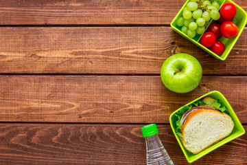 school lunch set with apple and vegetables in lunchbox background top view mock up