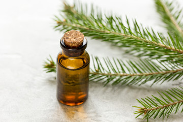 aromatherapy with organic spruce oils in glass bottles on white table background