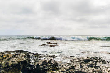 Rocks overlooking beach shoreline.
