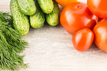 Cucumber, tomato, pepper and fennel on a white wooden background close up.