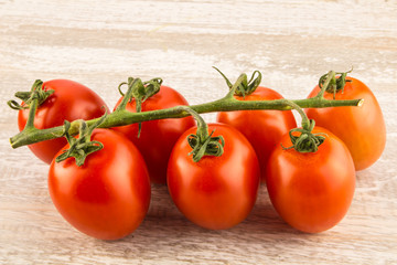 Tomatoes on a white wooden background close up.