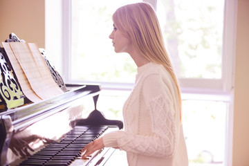 Beautiful girl playing piano