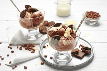 Delicious chocolate ice cream with nut flakes and cookies in glass bowl