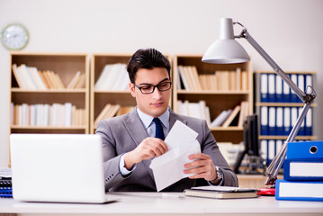 Businessman receiving letter envelope in office