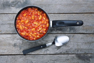 Stew pan with Italian butter beans on wooden background