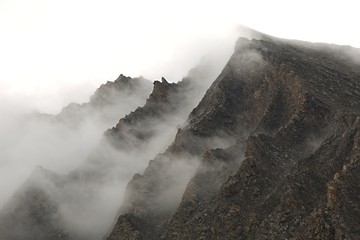 Mountain cliffs in fog