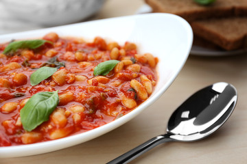 Plate with delicious Italian butter beans and spoon, close up