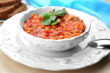 Beautiful dinnerware with delicious Italian butter beans on table, close up