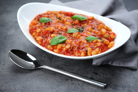 Plate with delicious Italian butter beans on table