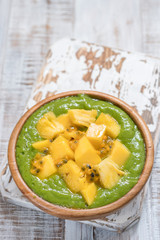 Green smoothie bowl with fruits and kale