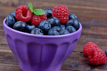 Berries in a bowl on wooden table