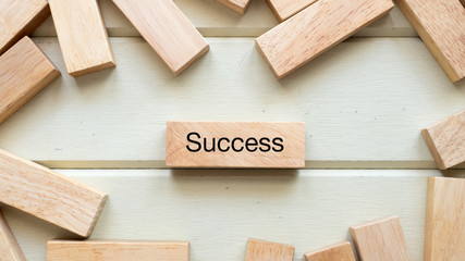 Naklejka na ściany i meble success word written on wood block close up