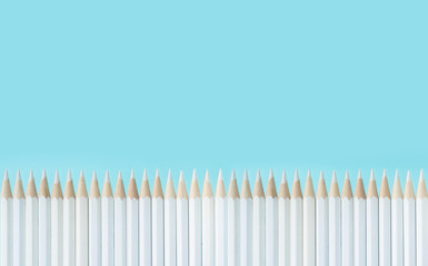 Business concept - lot of white pencils and stand on blue paper background like a fence. It's symbol of teamwork.