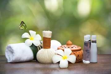 Obraz na płótnie Canvas Spa massage compress balls, herbal ball and treatment spa, Thailand, background green nature