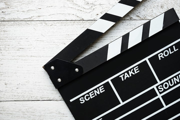 movie clapper on wood table © tatomm