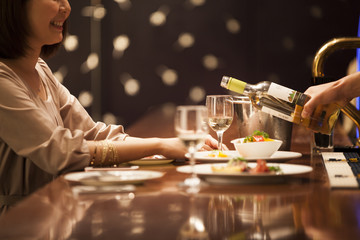 Women are pleased with poured wine