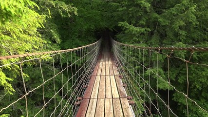 Walking across suspension bridge POV at Fall Creek Falls State Park in Tennessee
