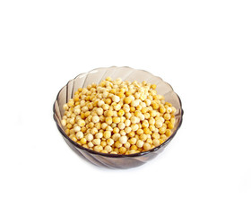 Dry peas in a glass bowl on a white background