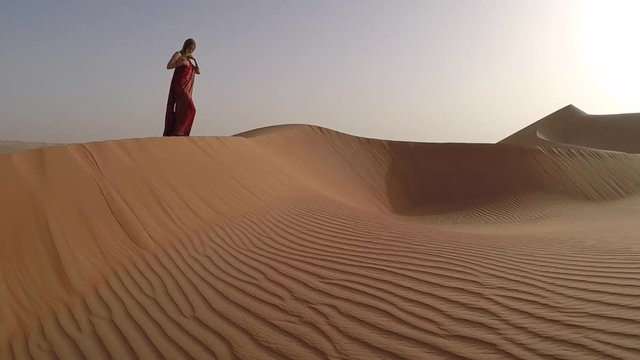 woman in red sari in Liwa desert 
