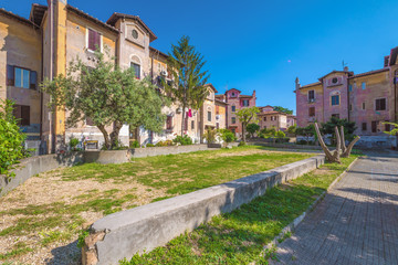 Naklejka premium Rome, Italy - The suggestive popular Garbatella quarter in Ostiense district, an agglomeration in Rococo style with gardens and the famous modern bridge named Settimia Spizzichino