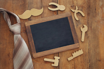 fathers day composition with wooden shape tools and blackboard