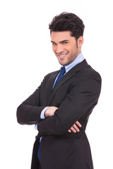 happy young business man with hands crossed smiling