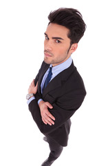 wide angle picture of a serious businessman with hands crossed