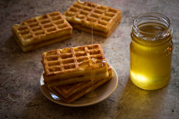 Baked waffles and organic sweet honey for breakfast