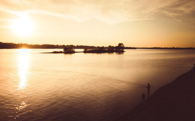 Obraz premium Fishing at sunset. A picturesque sunset over the Dnieper River