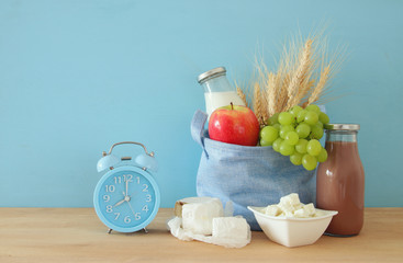Healthy breakfast next to alarm clock waking up at morning