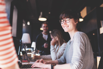 Portrait of woman manager. Group of business people working together in loft office. Marketing department discussing product strategy