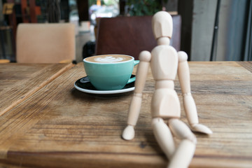 Hot mocha coffee or capuchino in the green cup on the wooden table
