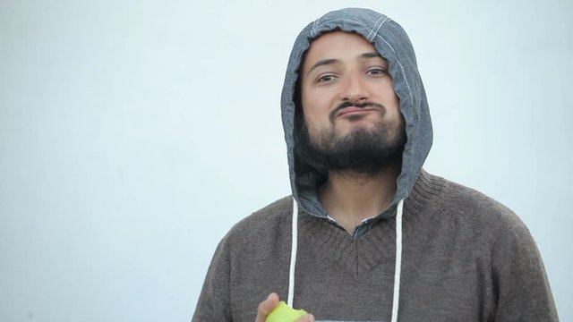 a man with a beard eating apple