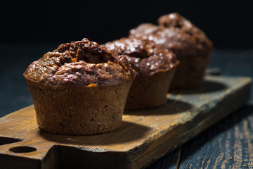 chocolate muffins on a wooden board