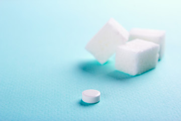 Fototapeta na wymiar Sugar substitute. Cubes sugar and stevia tablets