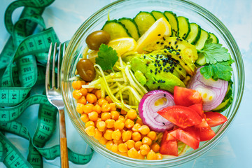 Buddha bowl - zucchini pasta, tape measure centimeter. Weight loss on a vegan diet concept.