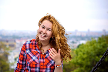 Funny cute american positive young woman have fun in city park, laughing and smile