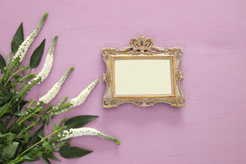 spring beautiful white flowers and blank victorian photo frame