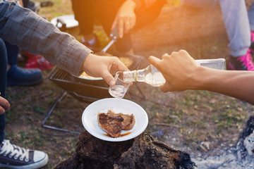 group friends cooking breakfast and drinking in weekend camping and feeling enjoying nature
