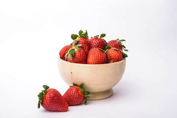 Bowl of strawberries isolated on white background