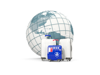 Luggage with flag of french southern territories. Three bags in front of globe