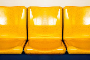 empty interior of electric train cabin, yellow seats in electric train, seats in electric trains. Bangkok skytrain.