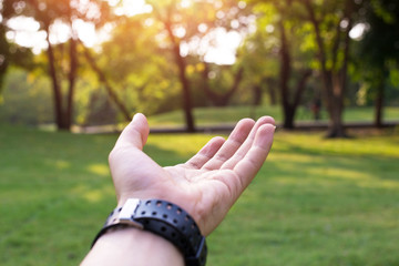 Praying Hands. Giving a helping hand, asking or offering help close-up shot of a Caucasian man in the park. hand with nature.