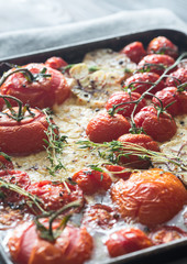 Fresh tomatoes, feta, garlic and thyme on the tray