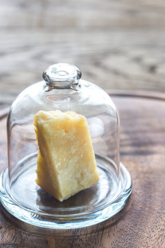Piece of Parmesan cheese under the glass dome