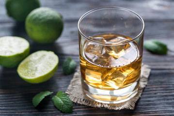 Glass of rum on the wooden background